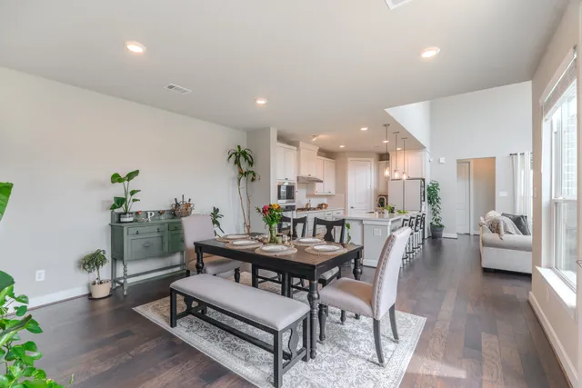 a dining room with furniture and wooden floor