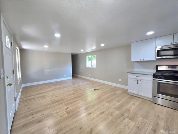a view of a kitchen with a stove cabinets and wooden floor