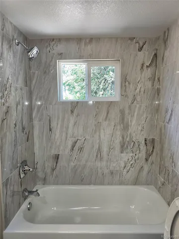 a bathroom with a bathtub and a shower