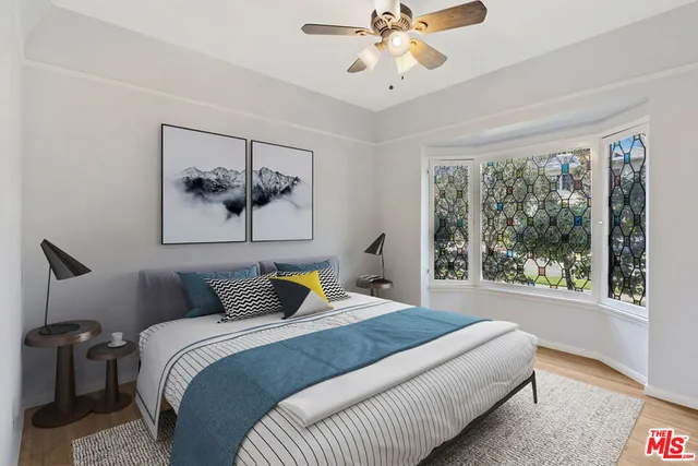 a bedroom with a large bed and a window