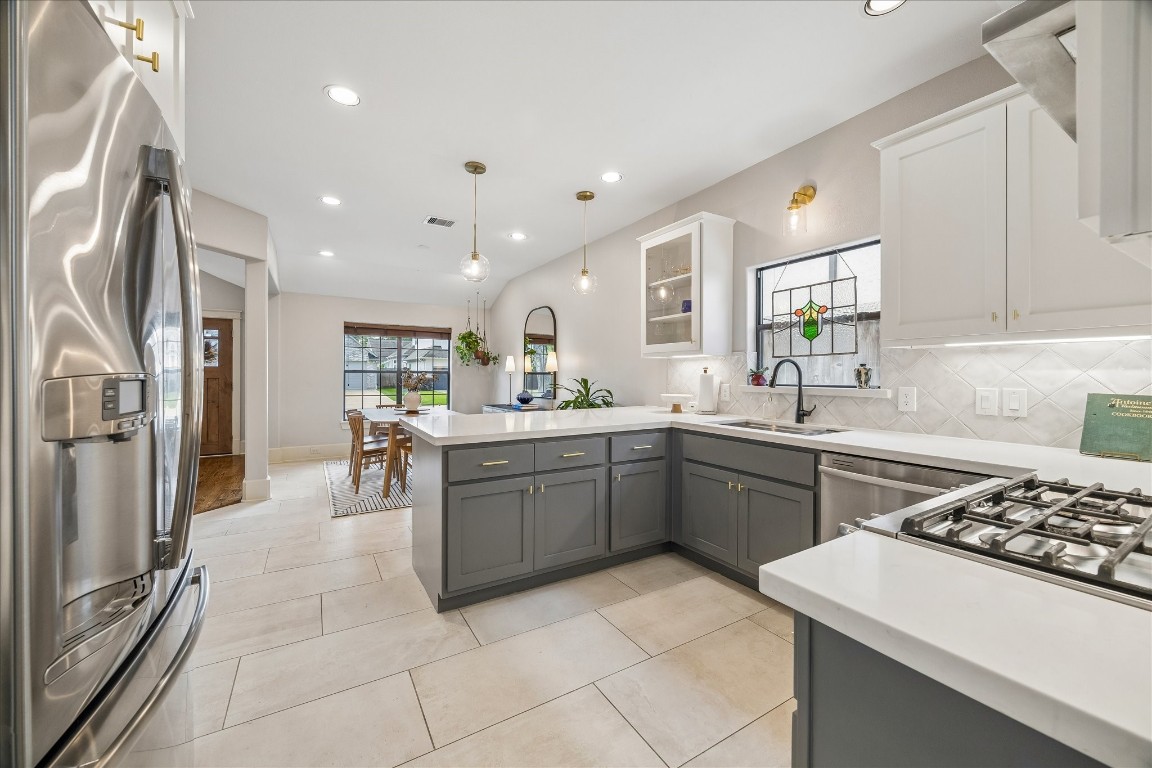1722 Lamonte Lane Houston, TX 77018 - Photo 9 of 34 a kitchen with a sink stainless steel appliances and cabinets