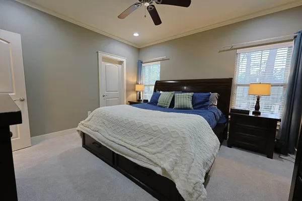 a bedroom with a bed lamps and a mirror