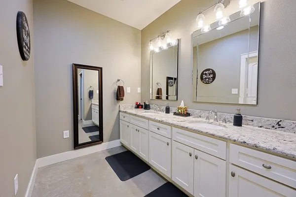 a bathroom with a double vanity sink and mirror