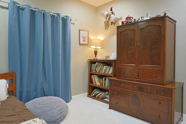 a bedroom with a bed and a cabinet