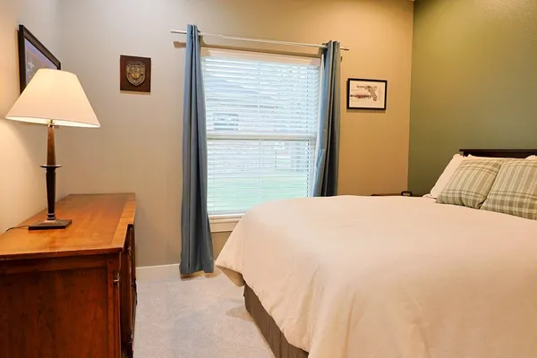 a bedroom with a bed and a lamp