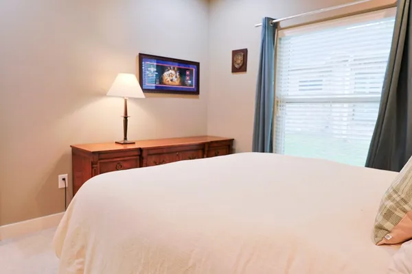 a bedroom with a bed and a painting on the wall