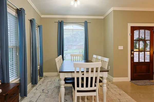 a view of a dining room with furniture and window