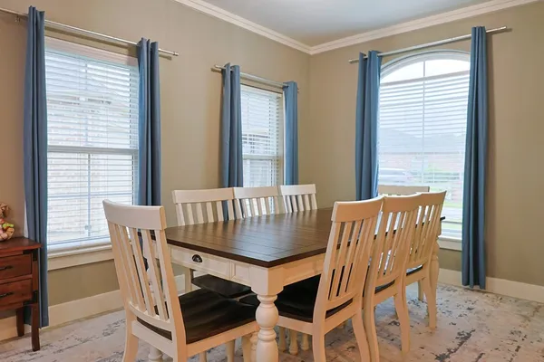 a view of a dining room with furniture and window