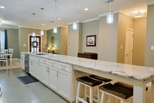 a spacious bathroom with a sink a large mirror and shower