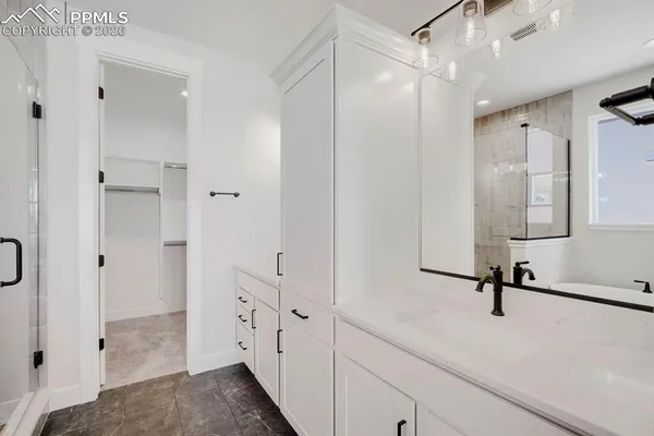 a bathroom with a shower sink and mirror