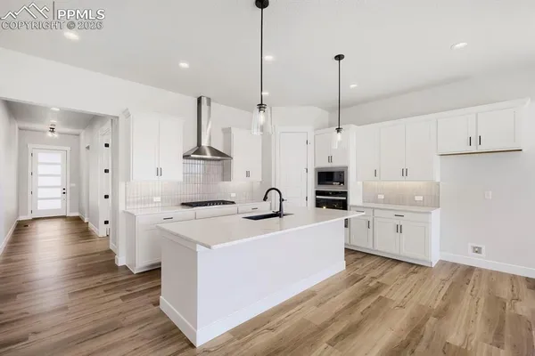 a kitchen with stove a sink and refrigerator
