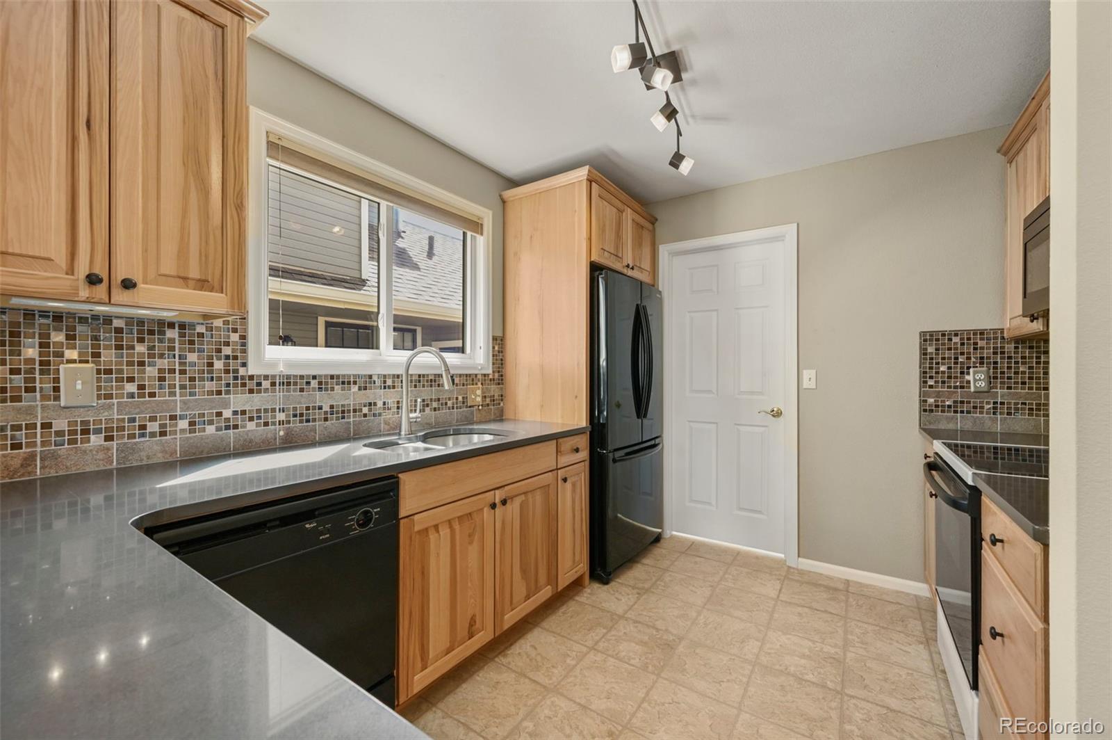 4829 Baldwin Place Boulder, CO 80301 - Photo 16 of 45 a kitchen with stainless steel appliances granite countertop a sink stove and refrigerator
