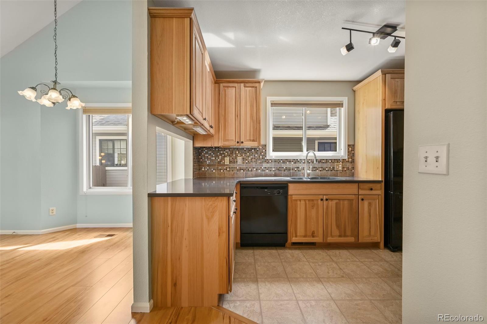4829 Baldwin Place Boulder, CO 80301 - Photo 17 of 45 a kitchen with stainless steel appliances granite countertop a sink a stove and a refrigerator