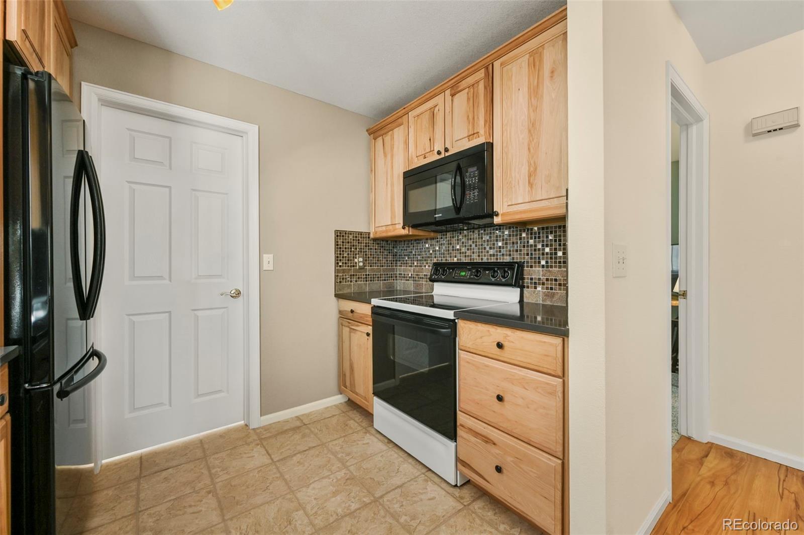 4829 Baldwin Place Boulder, CO 80301 - Photo 18 of 45 a kitchen with white cabinets and stainless steel appliances