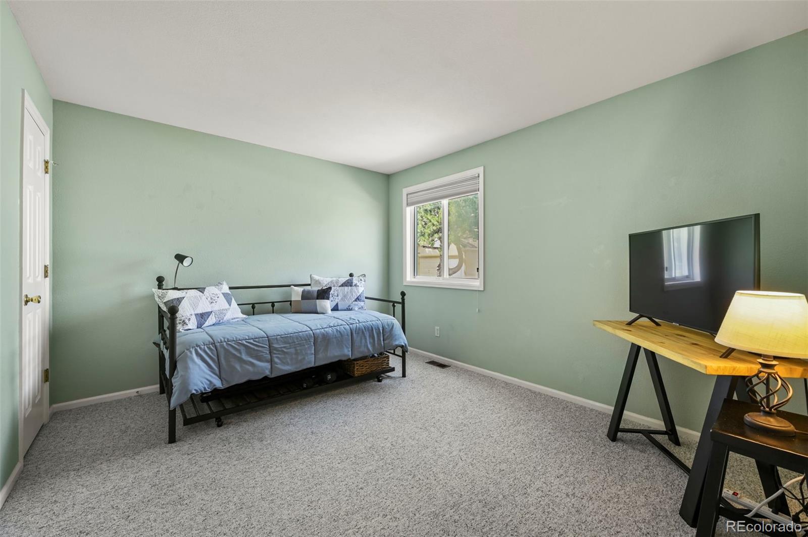 4829 Baldwin Place Boulder, CO 80301 - Photo 20 of 45 a bedroom with a bed a desk and chair
