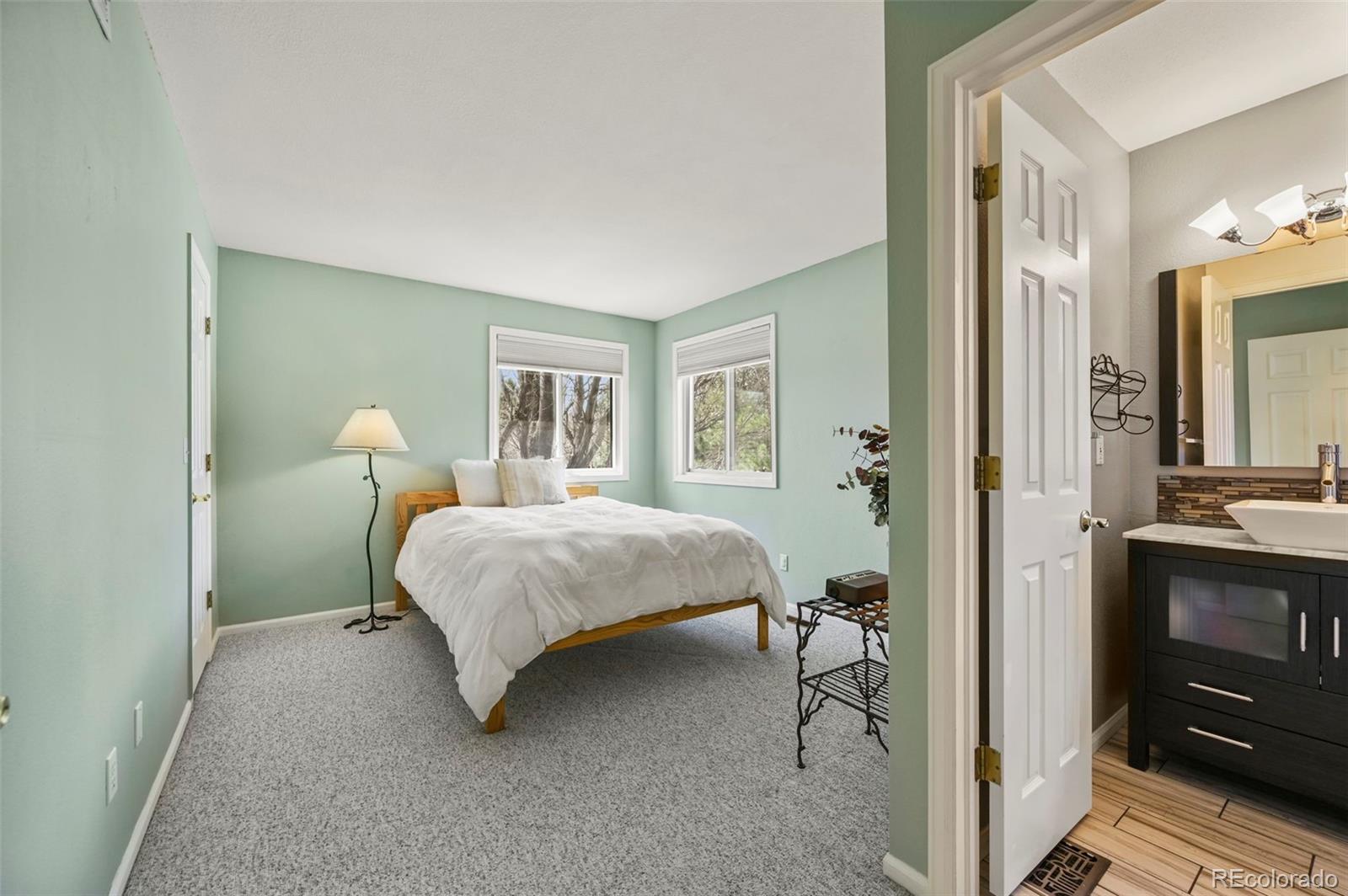 4829 Baldwin Place Boulder, CO 80301 - Photo 27 of 45 a bedroom with a bed and a mirror