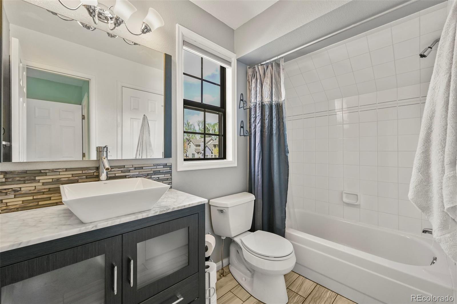 4829 Baldwin Place Boulder, CO 80301 - Photo 30 of 45 a bathroom with a sink toilet vanity and shower