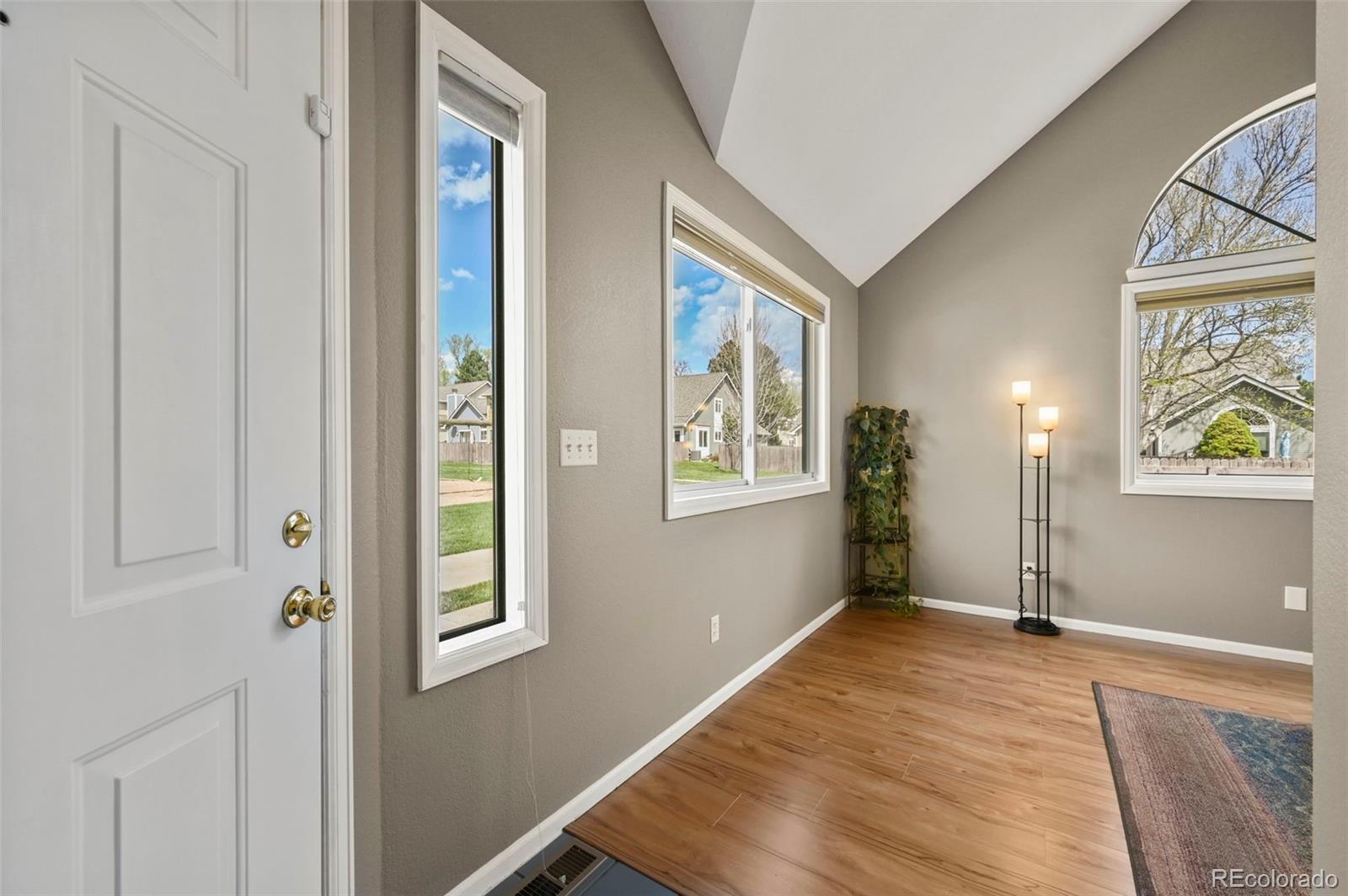 4829 Baldwin Place Boulder, CO 80301 - Photo 8 of 45 a view of an empty room with wooden floor and a window