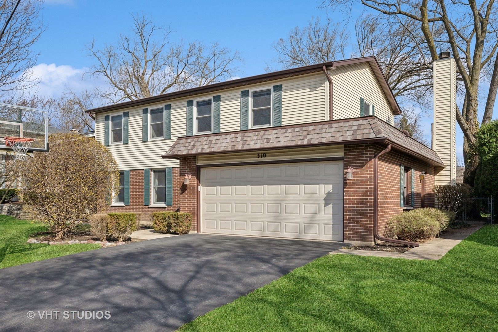 310 East Clarendon Street Arlington Heights, IL 60004 - Photo 1 of 20 a front view of a house with a yard and garage