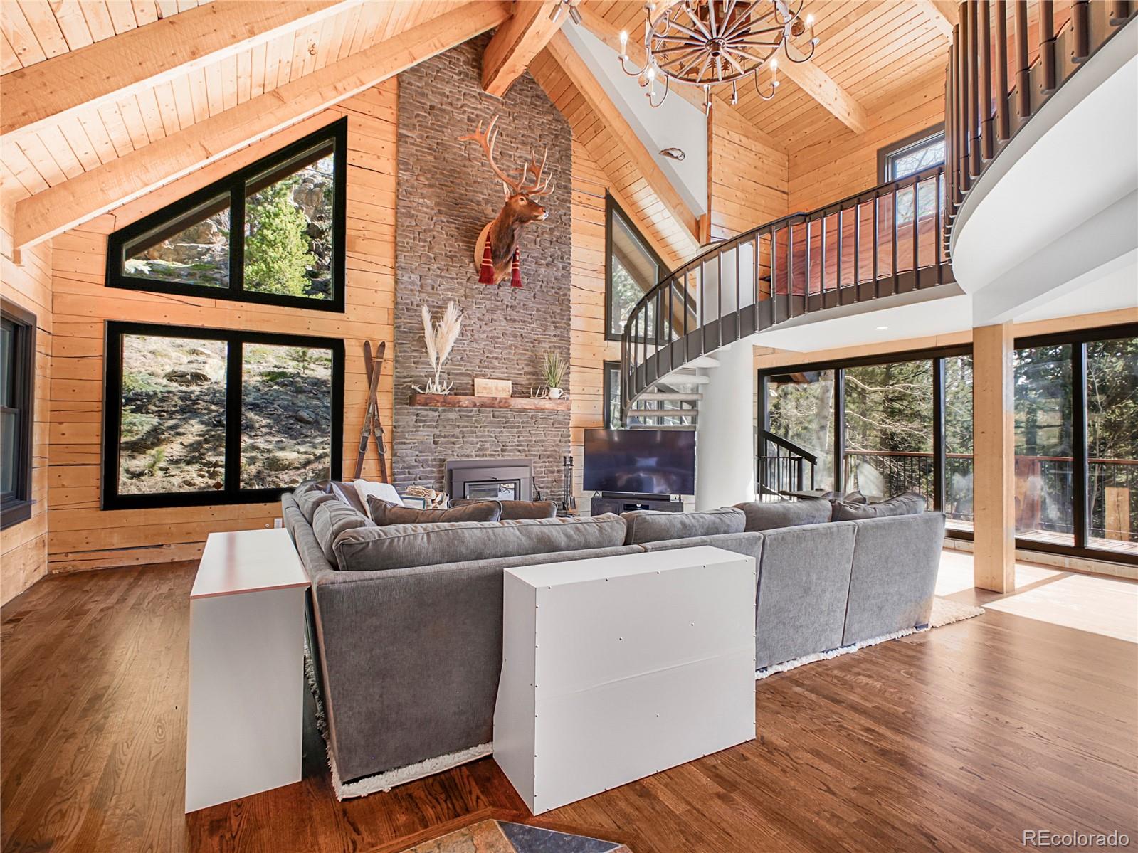 24 Pine Valley Road Evergreen, CO 80439 - Photo 4 of 50 a living room with furniture and large windows