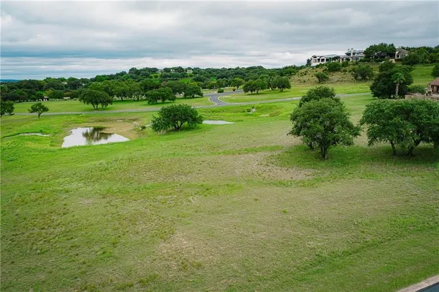a view of a big yard with large trees