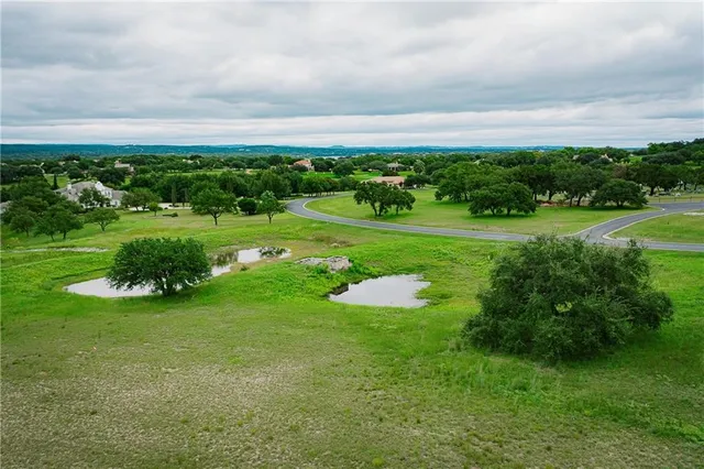 an aerial view of field with trees