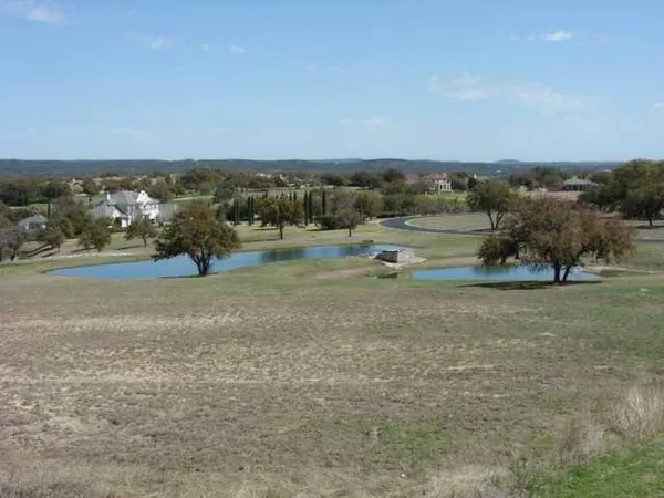an aerial view of field with trees