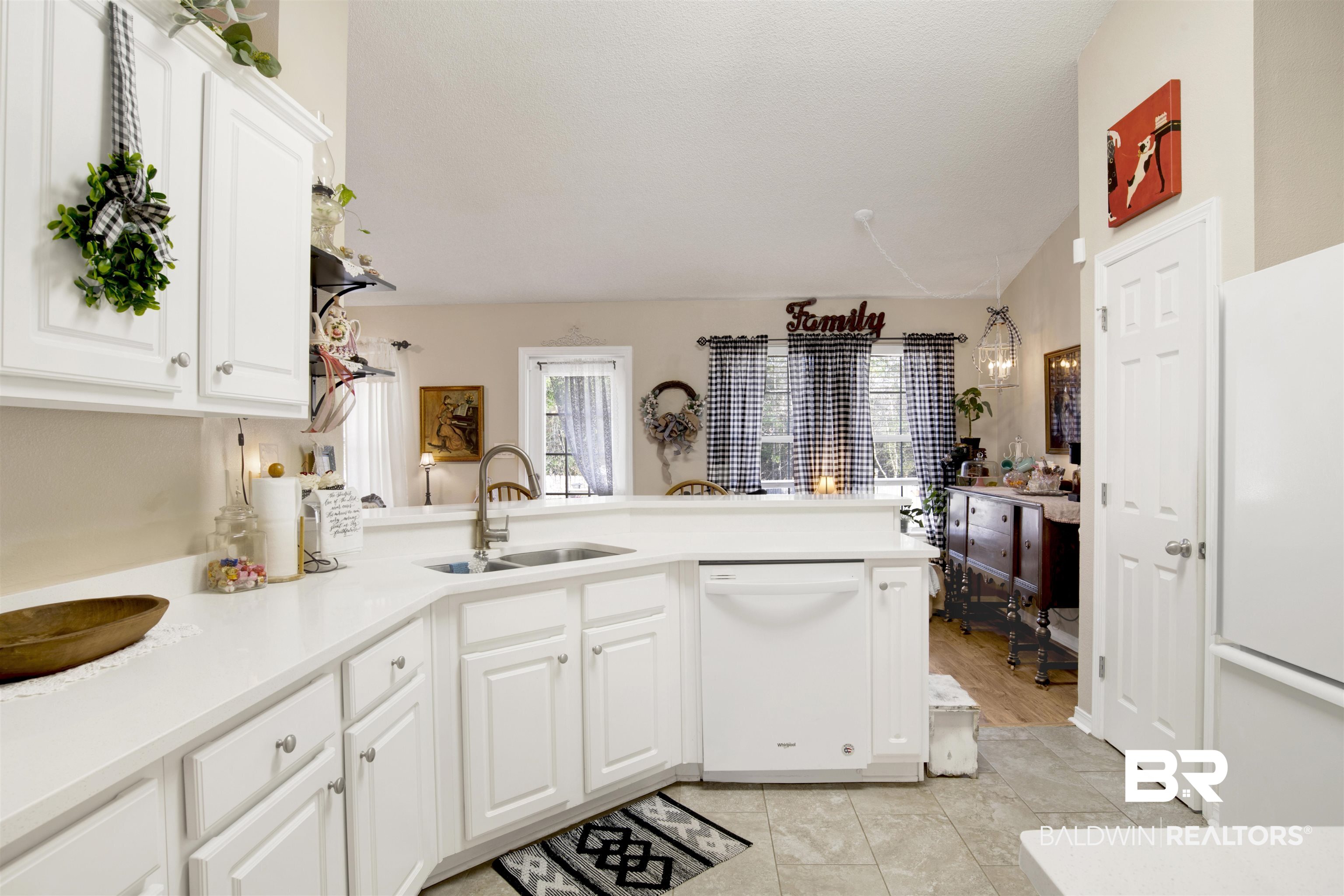 11697 Balsam Court Daphne, AL 36527 - Photo 12 of 31 Kitchen featuring white cabinetry, sink, white appliances, and kitchen peninsula