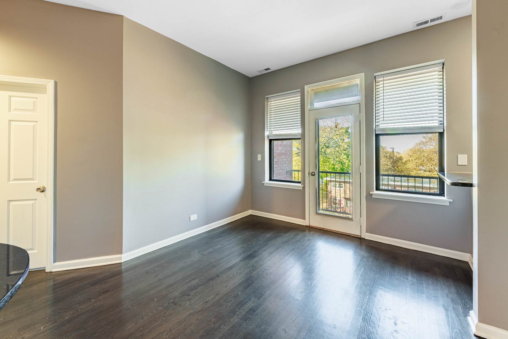 3704 South King Drive, Unit 3C Chicago, IL 60653 - Photo 14 of 26 an empty room with wooden floor and windows