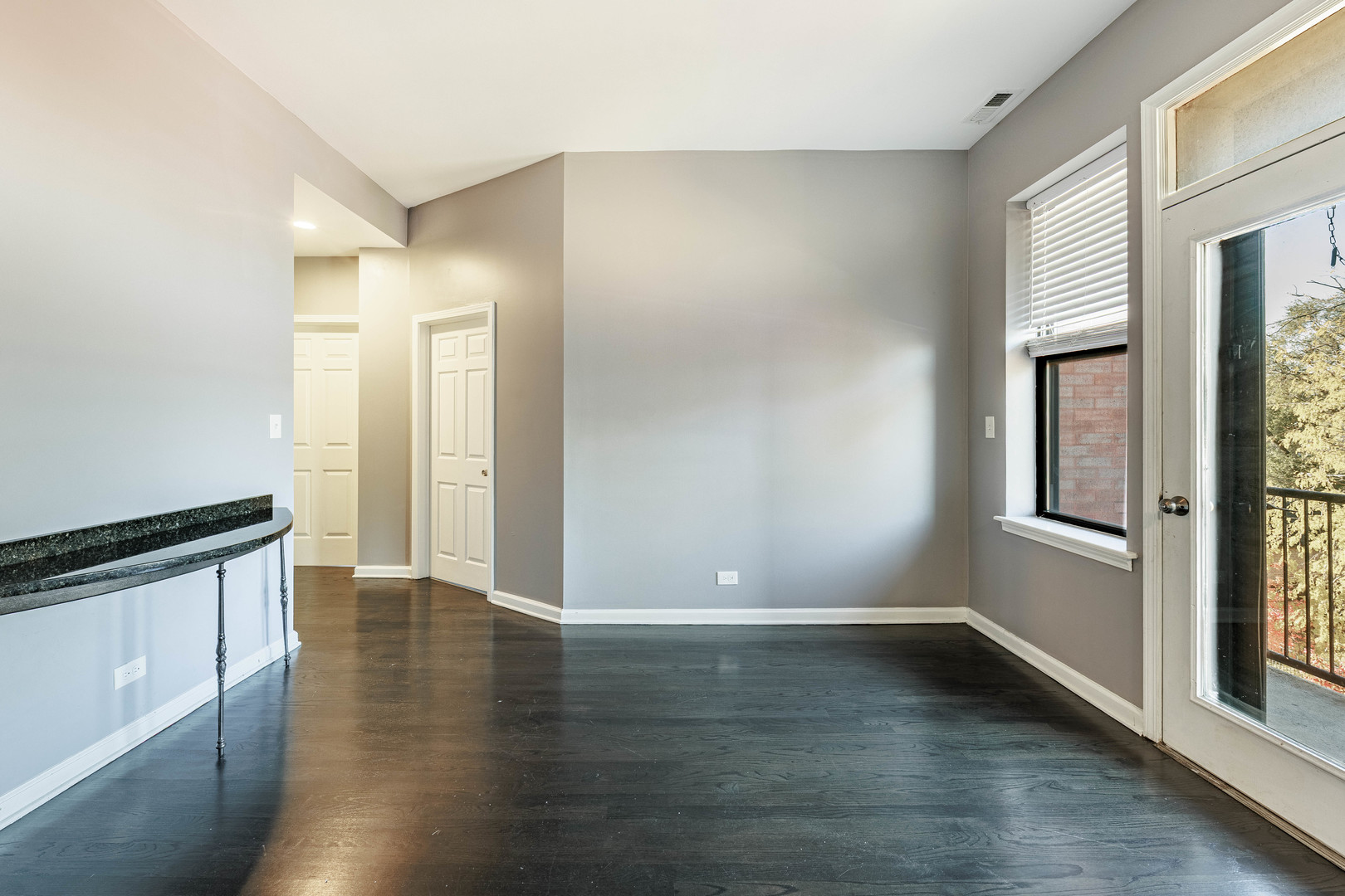 3704 South King Drive, Unit 3C Chicago, IL 60653 - Photo 15 of 26 wooden floor in an empty room with a window