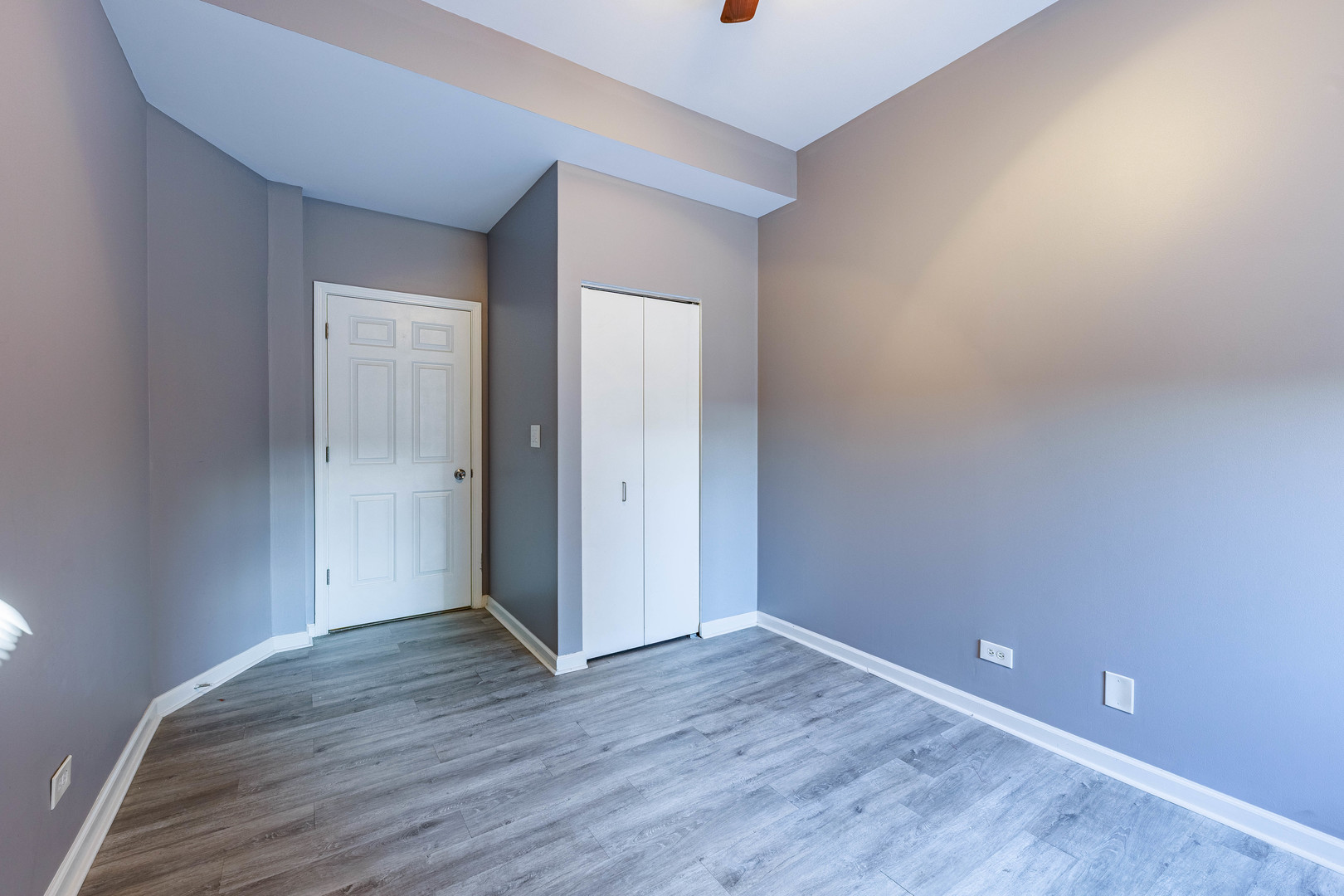 3704 South King Drive, Unit 3C Chicago, IL 60653 - Photo 23 of 26 a view of an empty room with wooden floor and closet