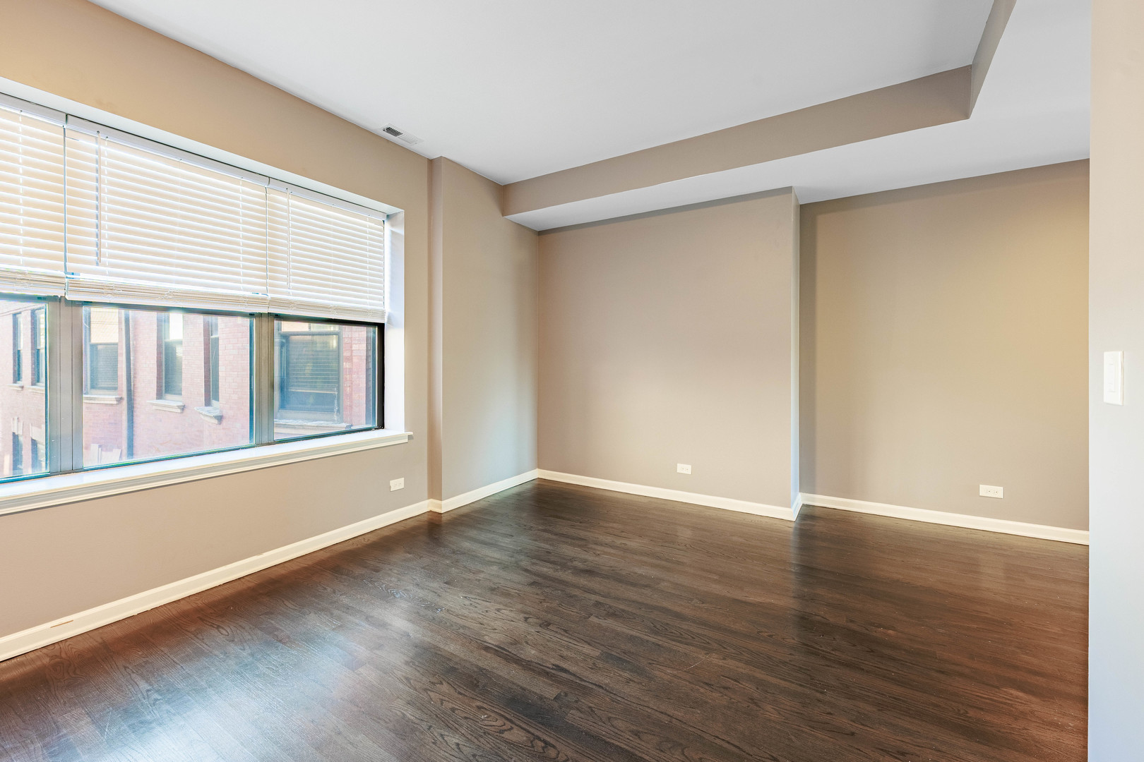 3704 South King Drive, Unit 3C Chicago, IL 60653 - Photo 4 of 26 a view of an empty room with wooden floor and a window