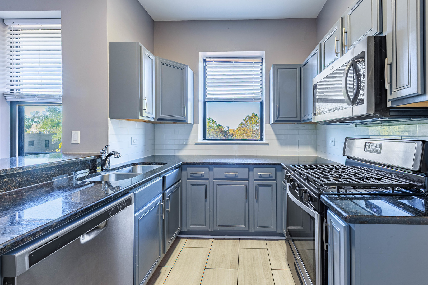 3704 South King Drive, Unit 3C Chicago, IL 60653 - Photo 10 of 26 a kitchen with stainless steel appliances a sink stove and cabinets