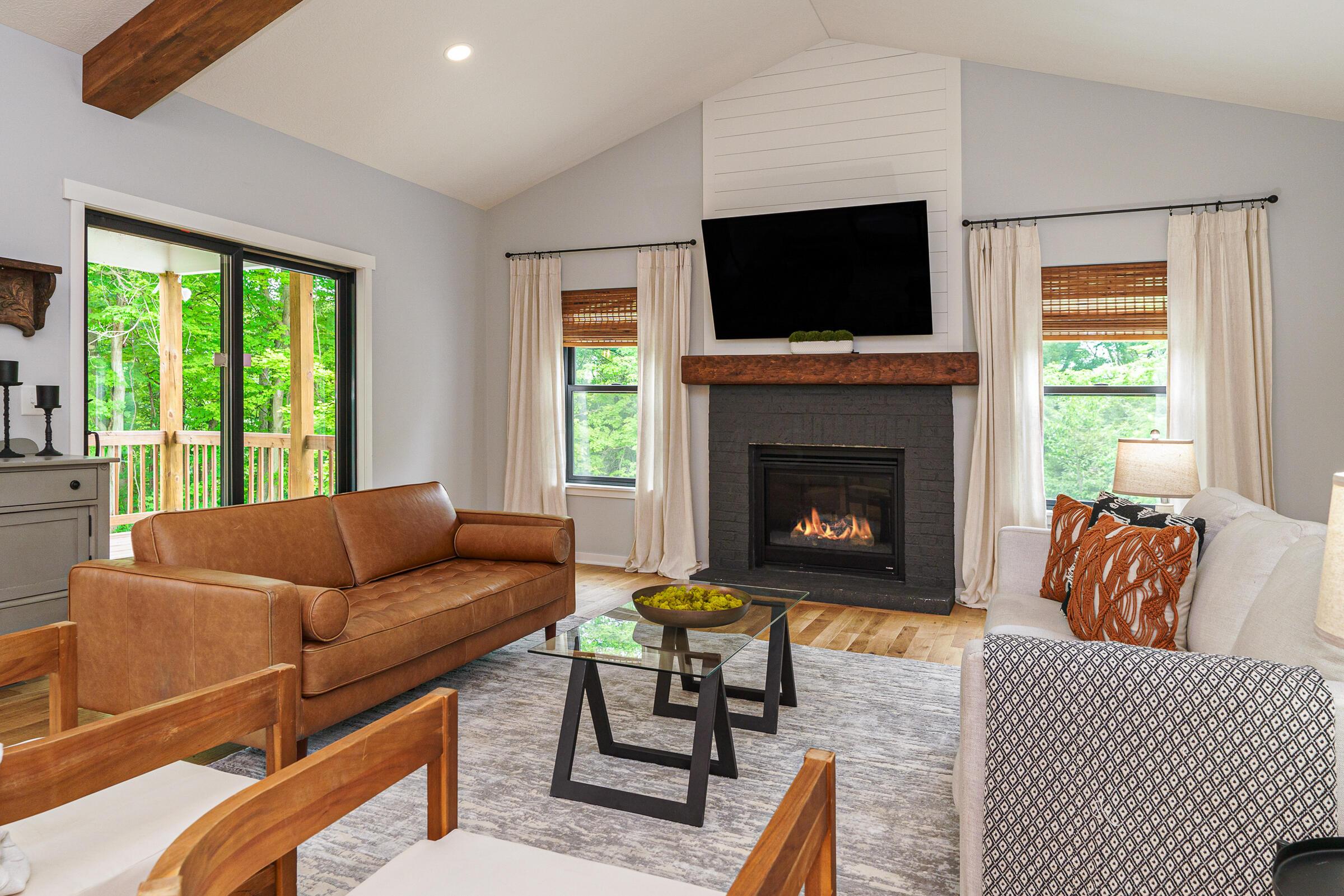 701 Ross Road Sunbury, OH 43074 - Photo 20 of 74 Great room boasts a gas log fireplace, vaulted and beamed ceiling and access to a private, raised deck overlooking the property