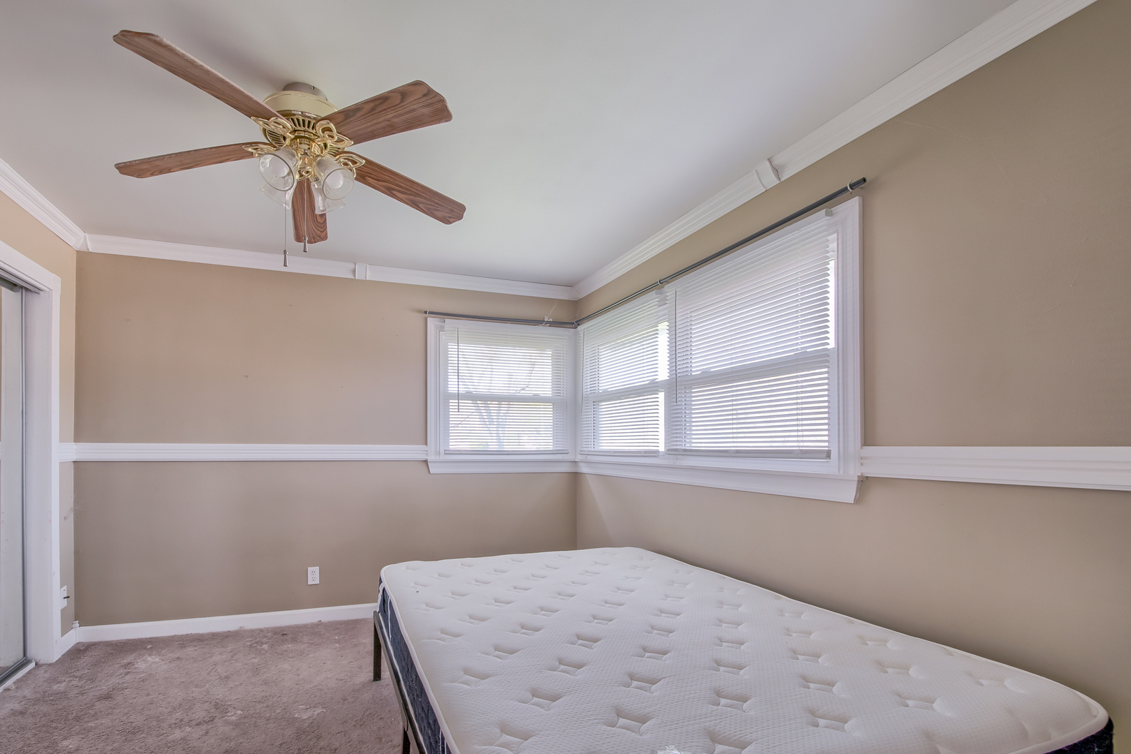 4113 West Crystal Lake Road McHenry, IL 60050 - Photo 9 of 14 an empty room with windows and fan