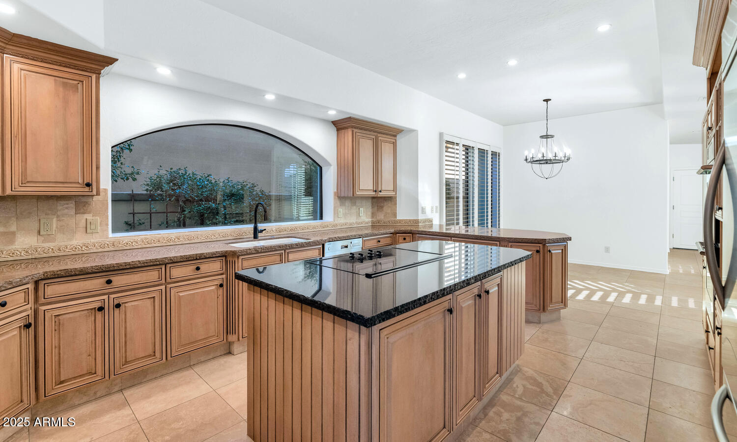 7878 East Gainey Ranch Road, Unit 25 Scottsdale, AZ 85258 - Photo 11 of 42 a kitchen with granite countertop a sink and a stove