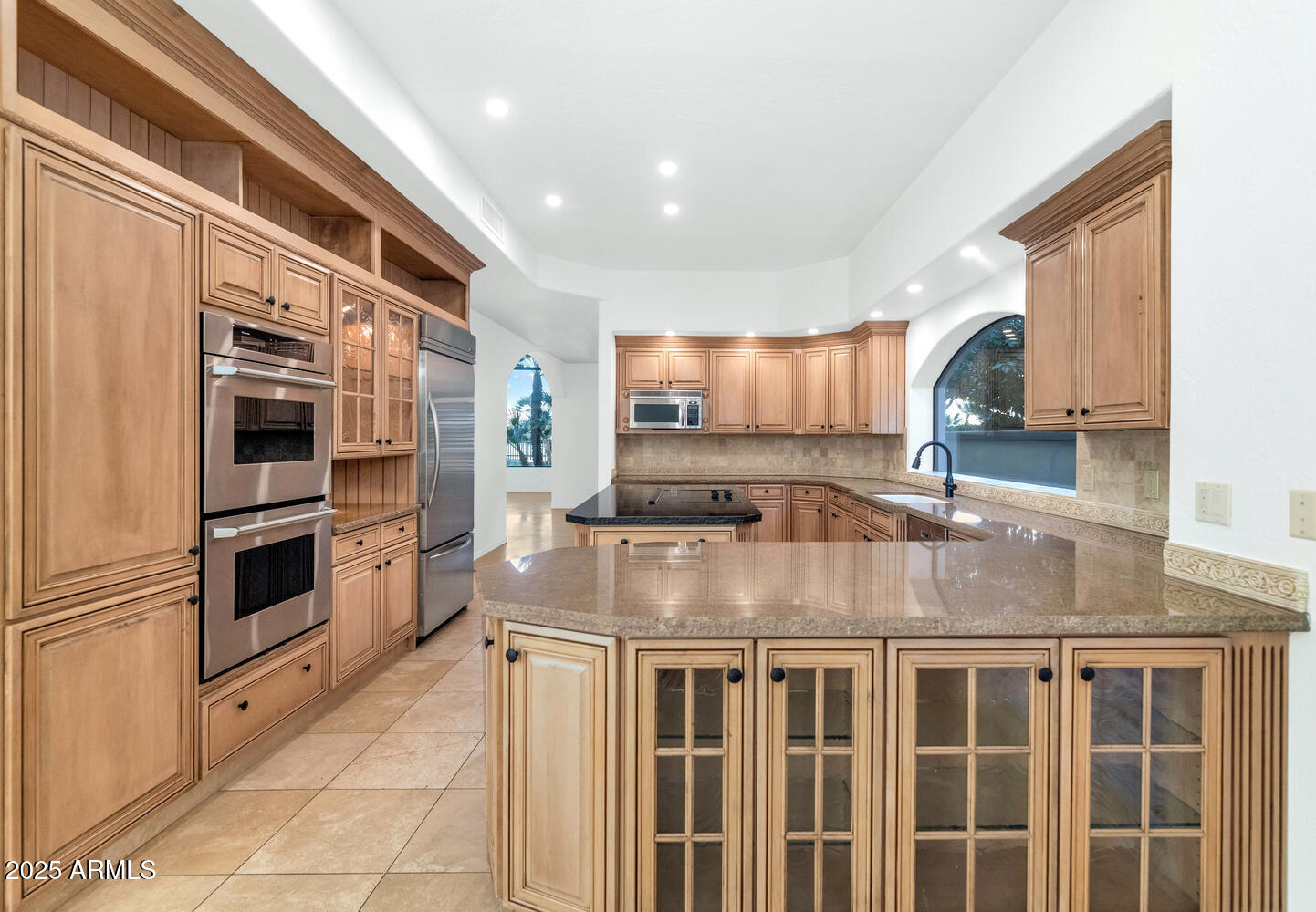 7878 East Gainey Ranch Road, Unit 25 Scottsdale, AZ 85258 - Photo 12 of 42 a kitchen with stainless steel appliances granite countertop a stove and a sink