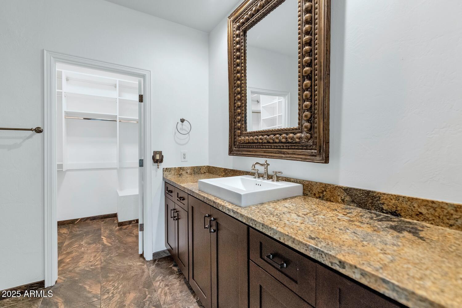 7878 East Gainey Ranch Road, Unit 25 Scottsdale, AZ 85258 - Photo 19 of 42 a bathroom with a granite countertop sink and a mirror