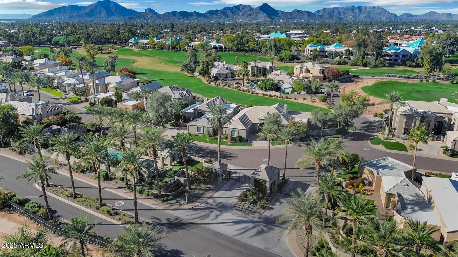 7878 East Gainey Ranch Road, Unit 25 Scottsdale, AZ 85258 - Photo 40 of 42 an aerial view of green landscape with trees houses and mountain view