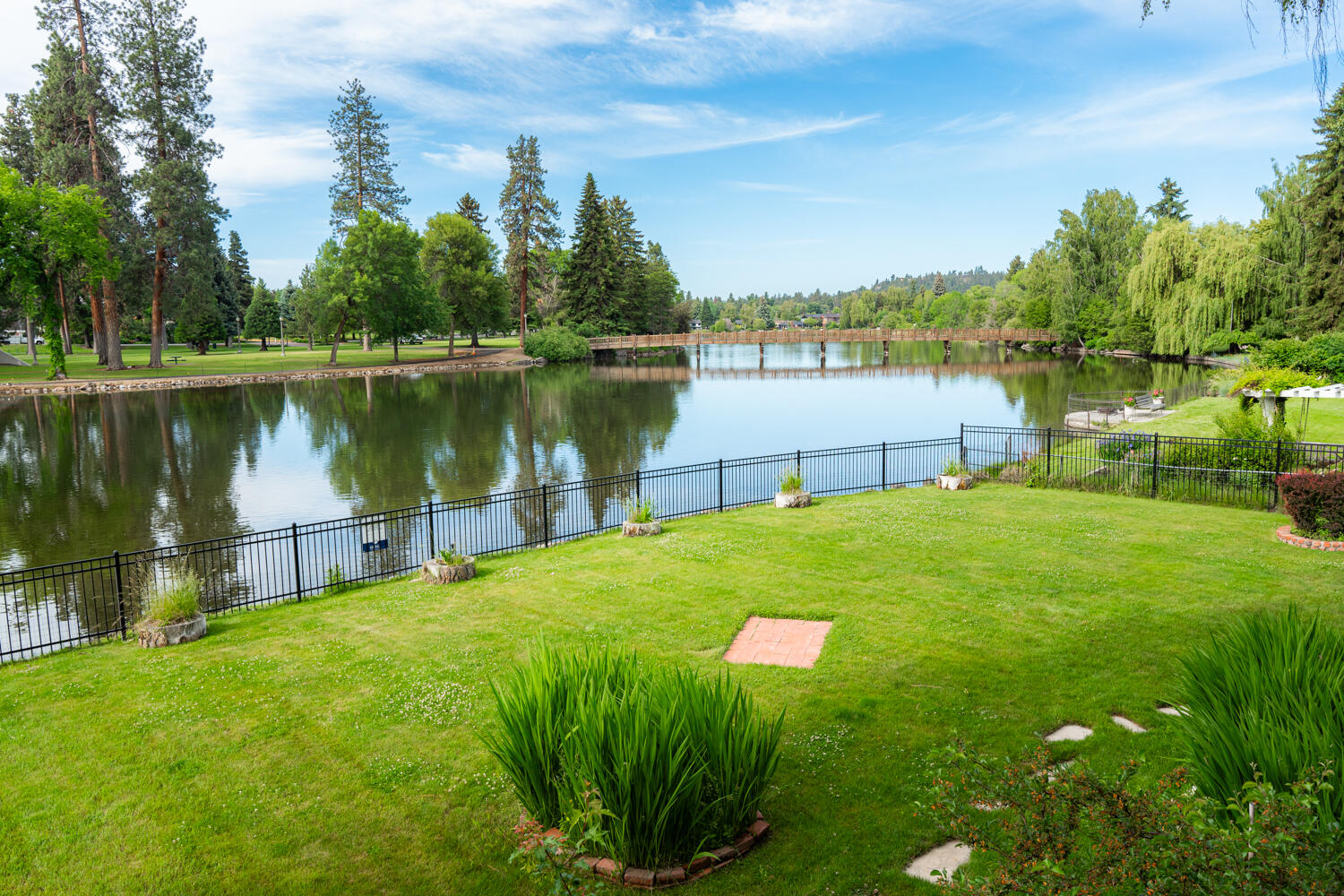 437 Northwest Drake Road Bend, OR 97703 - Photo 84 of 86 a view of a lake with a big yard and large trees