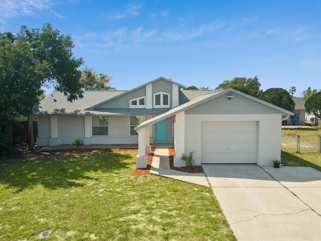 9402 Barnstead Lane Port Richey, FL 34668 - Photo 1 of 1 a front view of a house with a yard