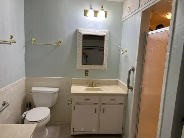 a view of an empty room with a chandelier fan