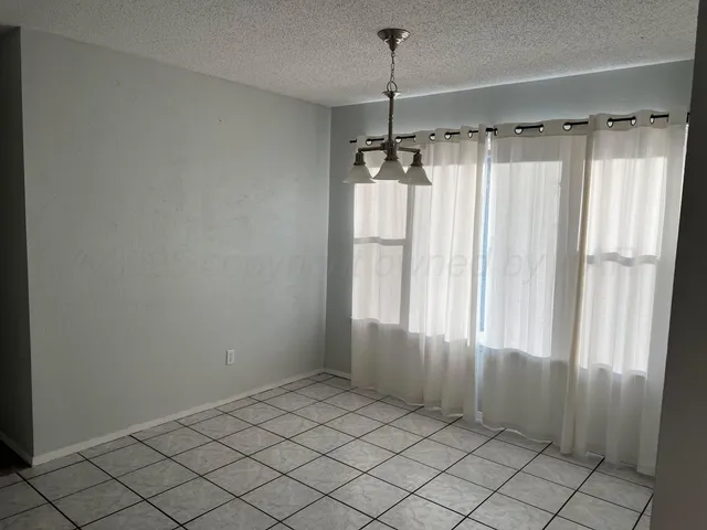 a view of a closet and window in a room