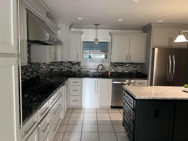 a kitchen with a sink stove and refrigerator