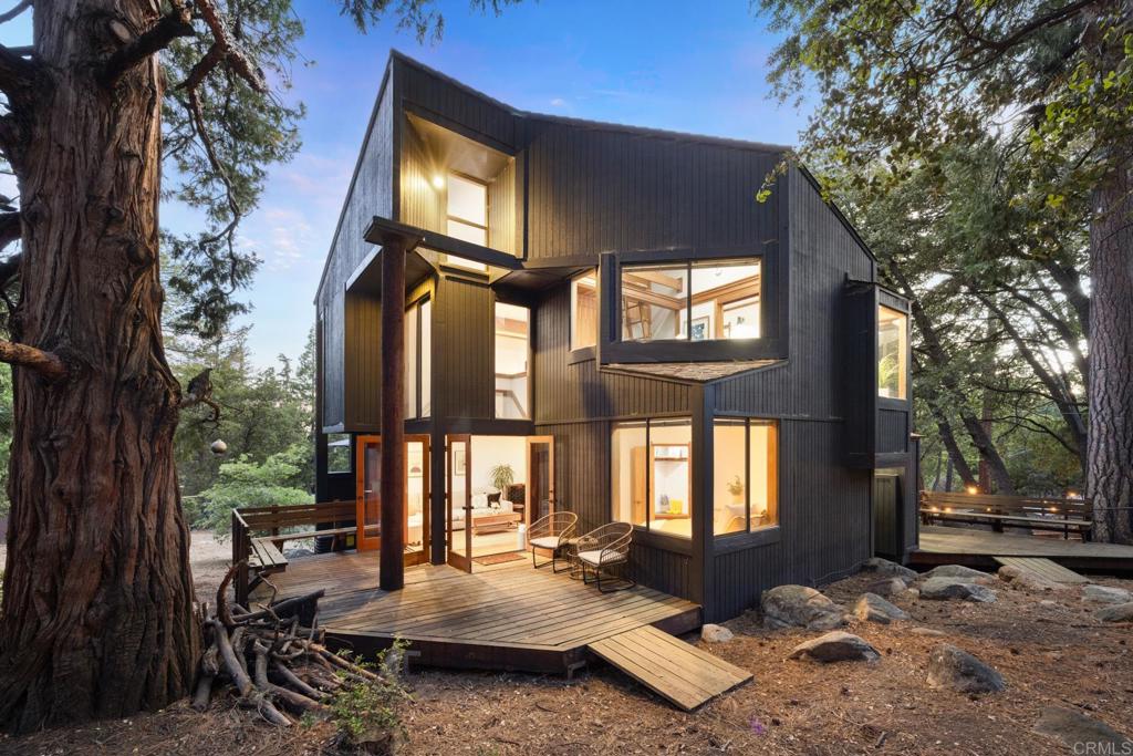 a backyard of a house with outdoor seating