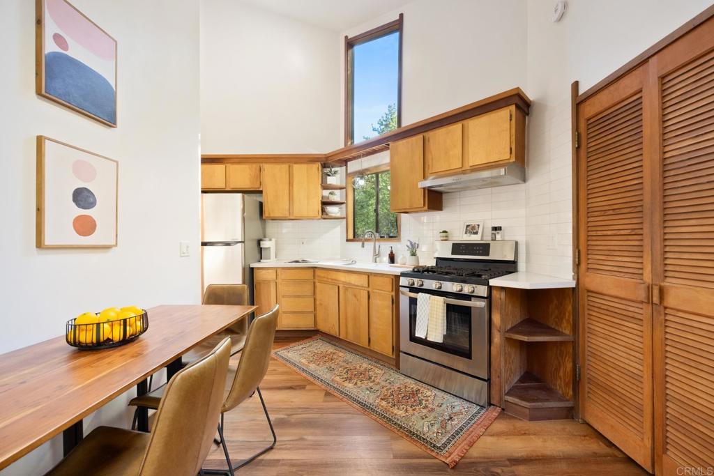 25650 Glen Road Idyllwild, CA 92549 - Photo 13 of 32 a kitchen with stainless steel appliances a stove a sink cabinets and a dining table