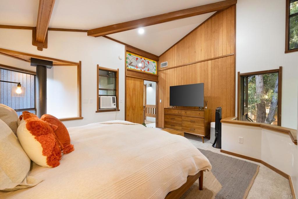 25650 Glen Road Idyllwild, CA 92549 - Photo 24 of 32 a bedroom with a bed and a flat tv screen on dresser