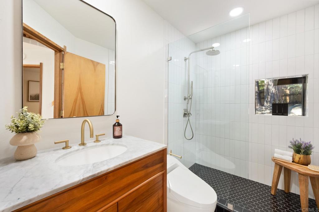25650 Glen Road Idyllwild, CA 92549 - Photo 8 of 32 a bathroom with a granite countertop sink mirror vanity and toilet
