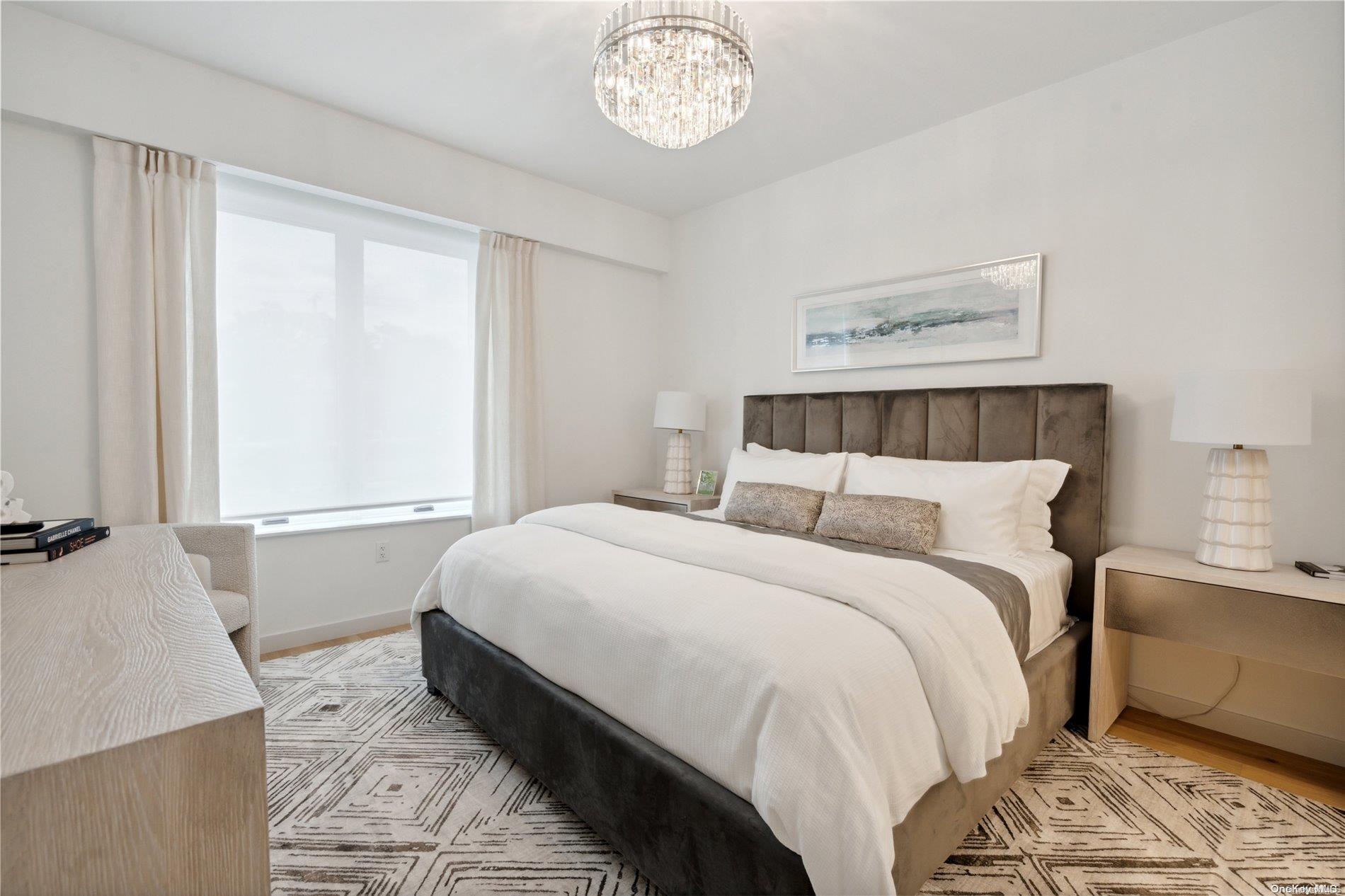 218 Middle Neck Road, Unit 105 Great Neck, NY 11021 - Photo 15 of 33 a bedroom with a bed and a window