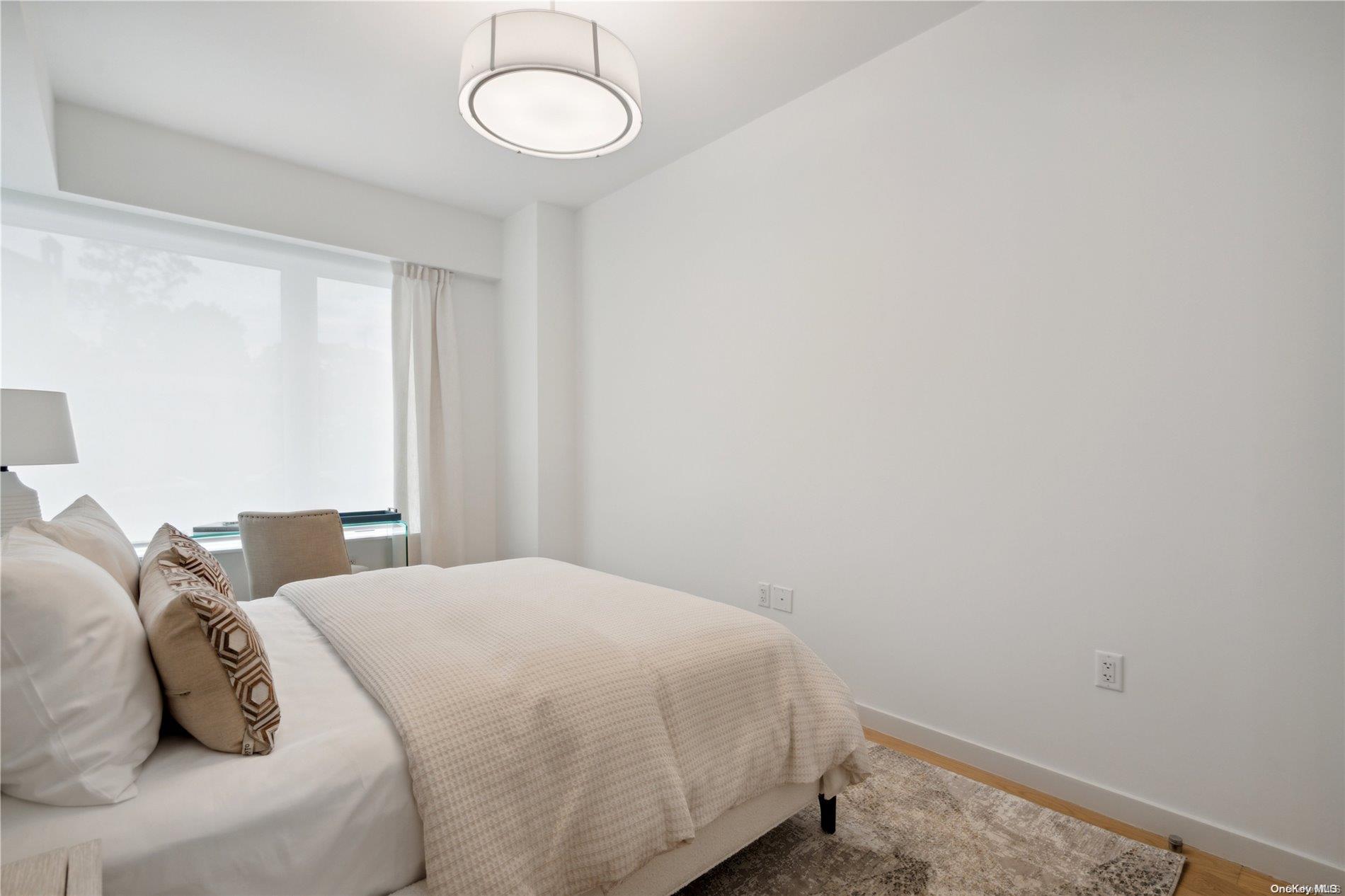 218 Middle Neck Road, Unit 105 Great Neck, NY 11021 - Photo 19 of 33 a bedroom with a bed and a window